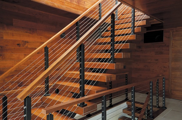 An Image Of Modern Staircase Span Of The Wooden Wall With Steel Metal Railings And Gray Floor.