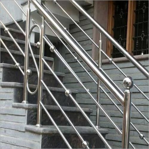 An Image of Outdoor Concrete Staircase With Stainless Steel Handrail.